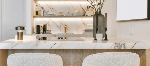 Elegant modern kitchen with marble island, open shelving, and bar stools.