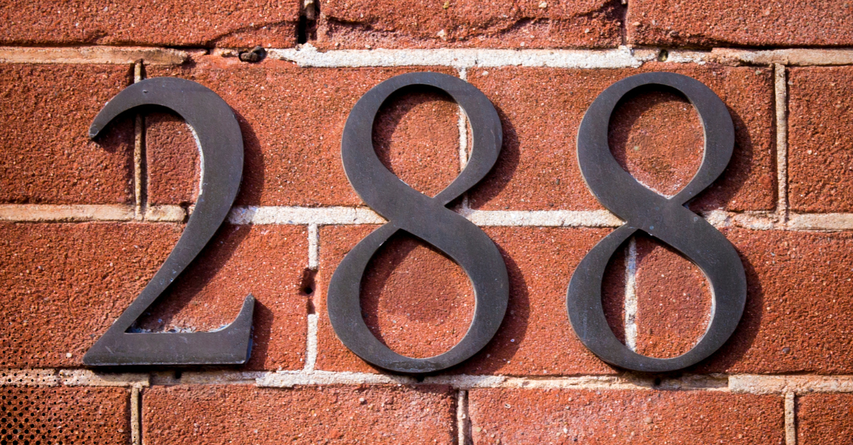 House number 288 in black metal on a red brick wall