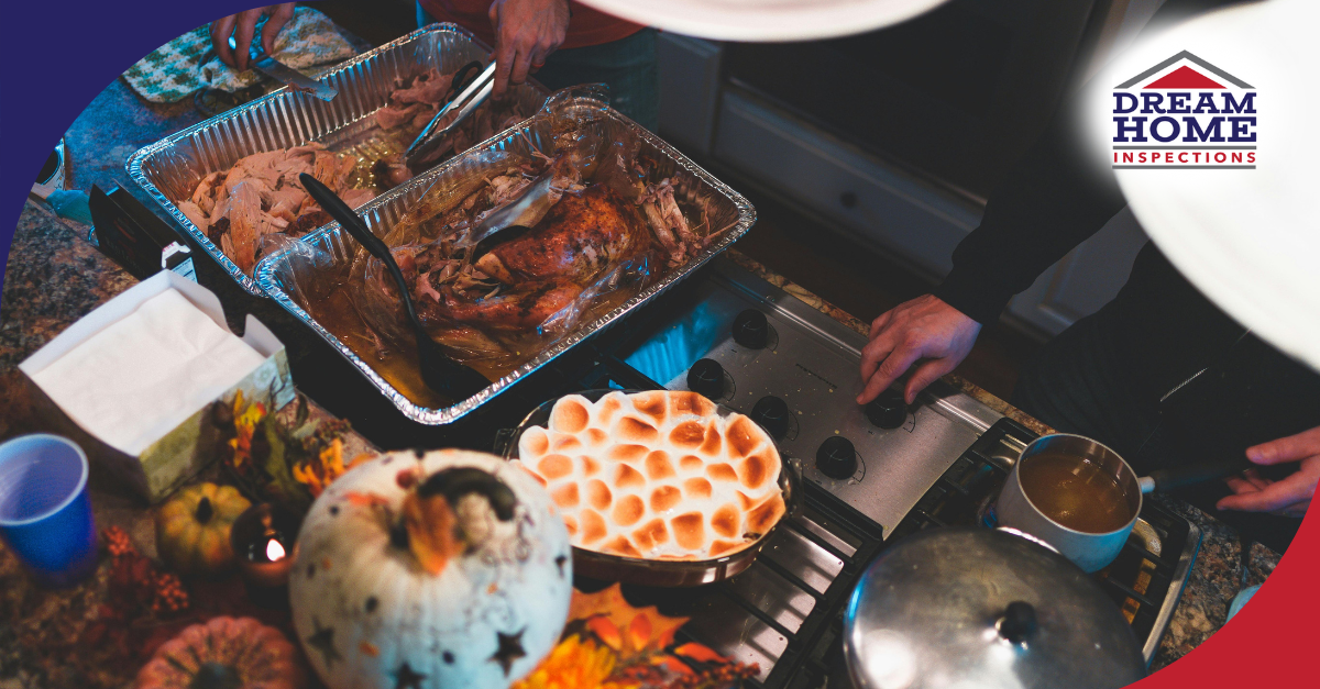 Close-up of a Thanksgiving meal with turkey, marshmallow-topped sweet potatoes, and a festive autumn setting on the kitchen counter.